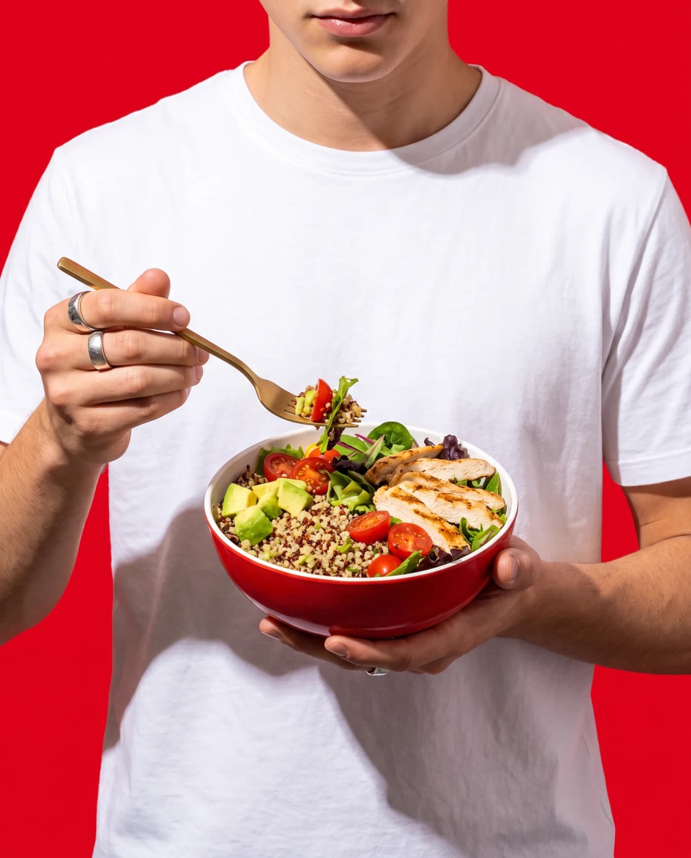 A person holding a Le Supreme bowl against a red backdrop
